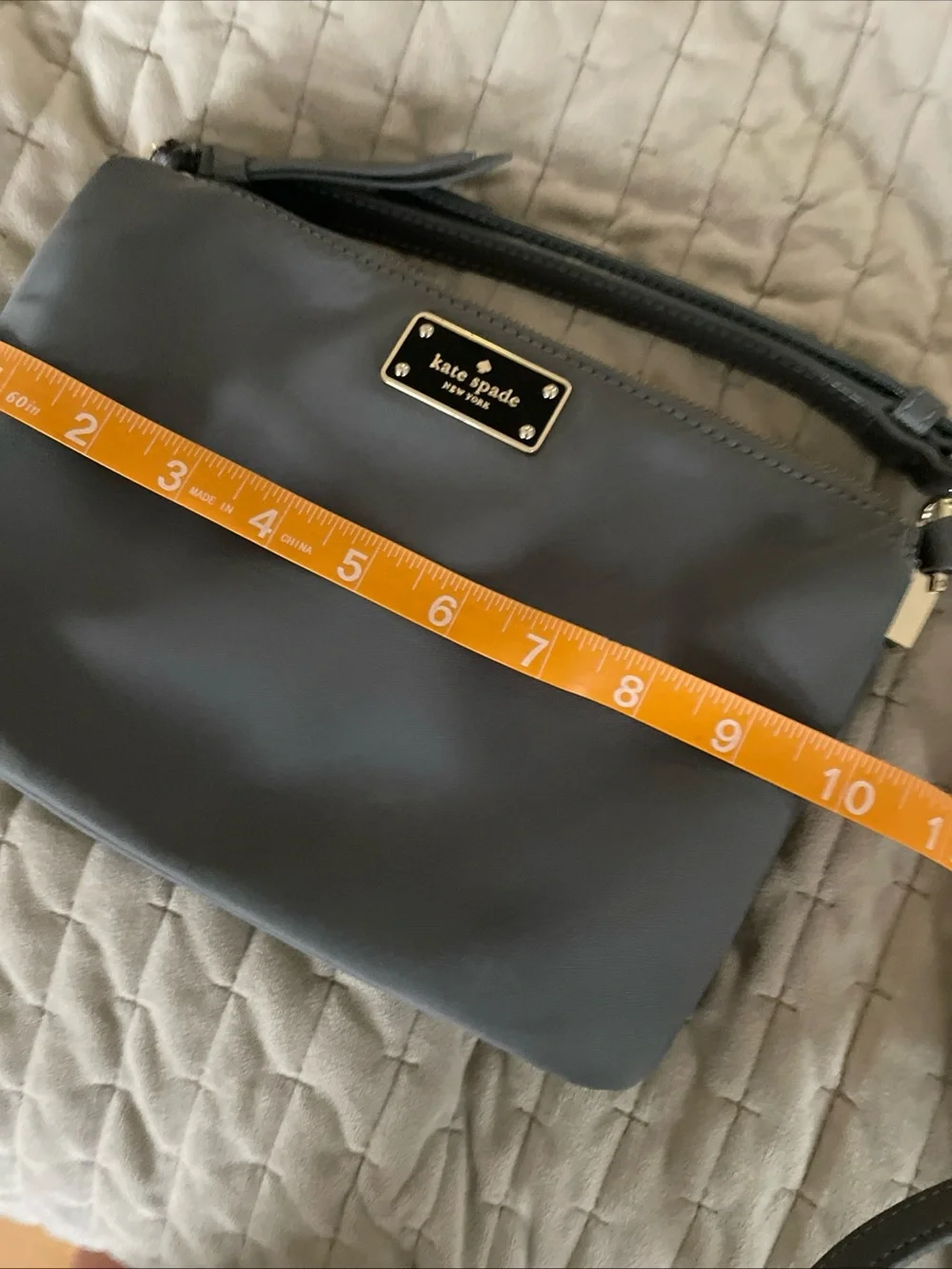 kate spade gray nylon crossbody with gold logo plaque